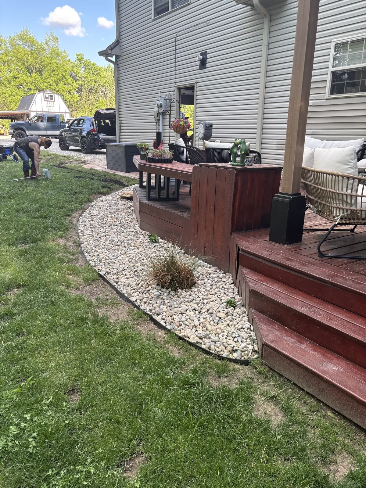 A river-rock bed laid along a deck.